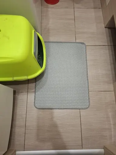 Photo d'un acheteur montrant le tapis de litière Minopatte en situation